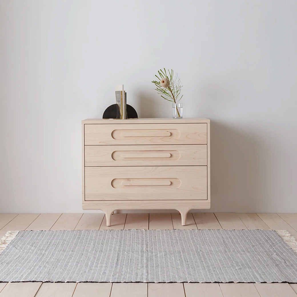 Front view of Kalon Caravan Dresser with items on top in -- Color_Oiled Ash