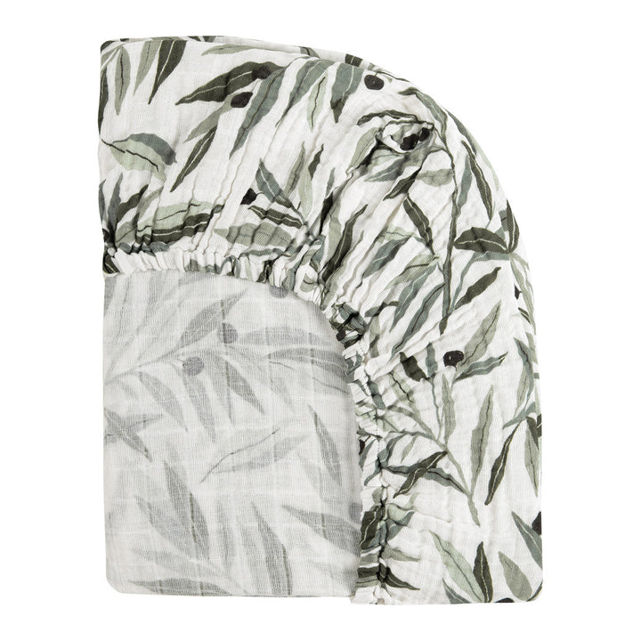 Back corner view of Babyletto's All-Stages Midi Crib Sheet In GOTS Certified Organic Muslin Cotton in -- Color_Olive Branches