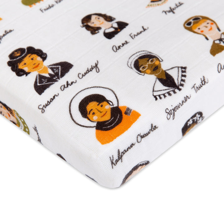 Corner view of Babyletto's All-Stages Midi Crib Sheet In GOTS Certified Organic Muslin Cotton in -- Color_Women In History