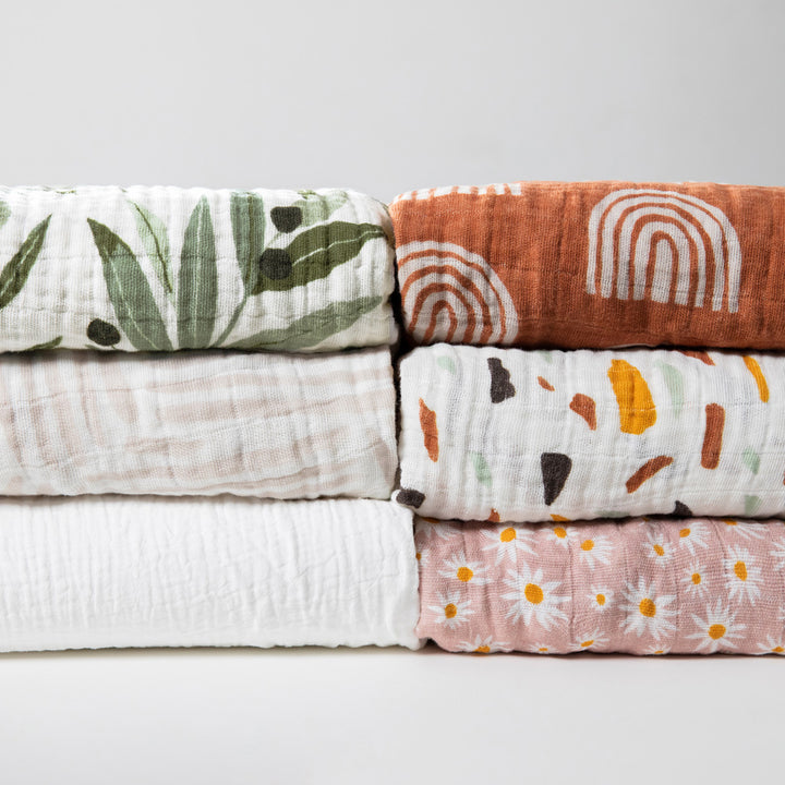 Six Babyletto's All-Stages Midi Crib Sheet In GOTS Certified Organic Muslin Cotton in -- Color_Olive Branches / Oat Stripe / White / Terracotta Rainbow / Terrazzo / Daisy