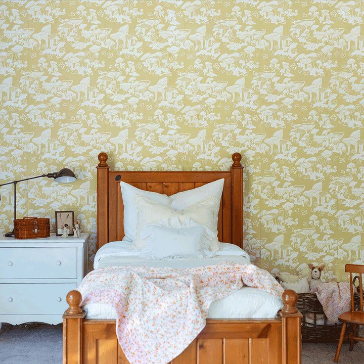 Lifestyle front view of bed in a room furnished with Anewall Forest Floor Mushroom Wallpaper